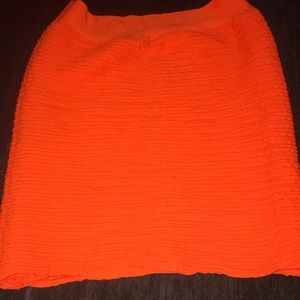 Stretchy orange mini skirt.